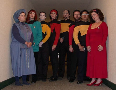 What the heck? Guinan isn't white, Deanna never wore a red dress, it was turquoise, Geordi was black not Asian, Ensign Ro has her earring on and is Beverly here a man? Sheesh, stupid fans.